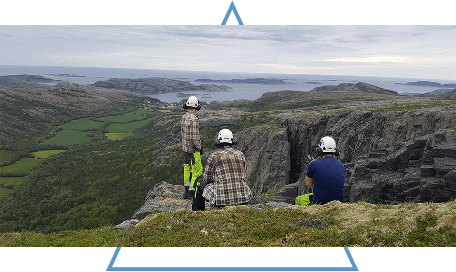 Three engineers looking towards a vale